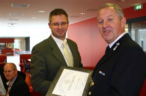 Chapter President Commander  Willem Voogt, RNLN (r), hands a certificate of appreciation to Mr.Kees Möhring, board member of the Netherlands Forensic Institute, for his presentation.
